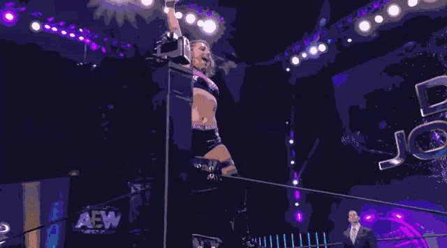 a woman in a wrestling ring with the number 12 on her waist
