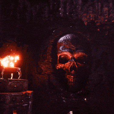 a large skull on a wall with a pot of fire in the background