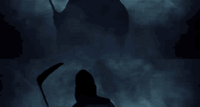 a silhouette of a person in a hooded cape holding a sword