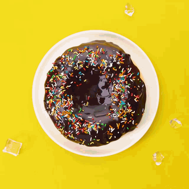 a donut with chocolate icing and sprinkles on it