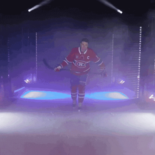 a hockey player in a red and white jersey with the letter c on the front