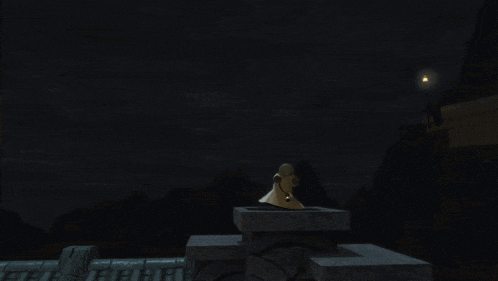 a statue of a man sitting on top of a chimney with a light in the background