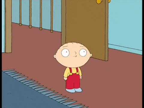 a cartoon character standing in front of a door wearing red overalls