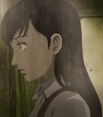 a close up of a girl 's face with the number 1 on the wall