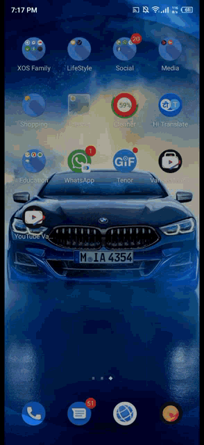 a blue car with the license plate m 1a 4354 is on the screen of a phone