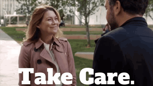 a woman in a trench coat talks to a man in a black jacket with the words take care on the bottom