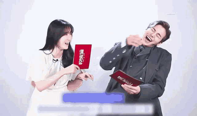 a man and a woman are laughing while holding a sign that says tower on it
