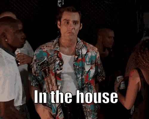 a man in a colorful shirt is standing in a crowd with the words in the house written on the bottom