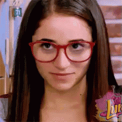 a close up of a woman wearing glasses with the word juice on her chest