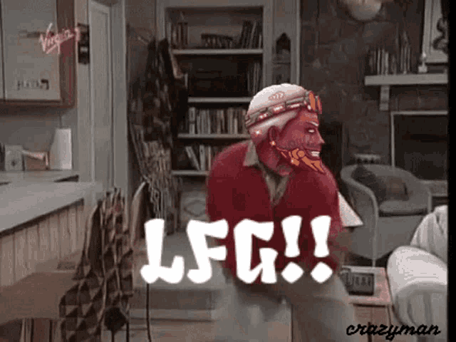 a man in a red jacket is standing in a living room with the words lfg written above him