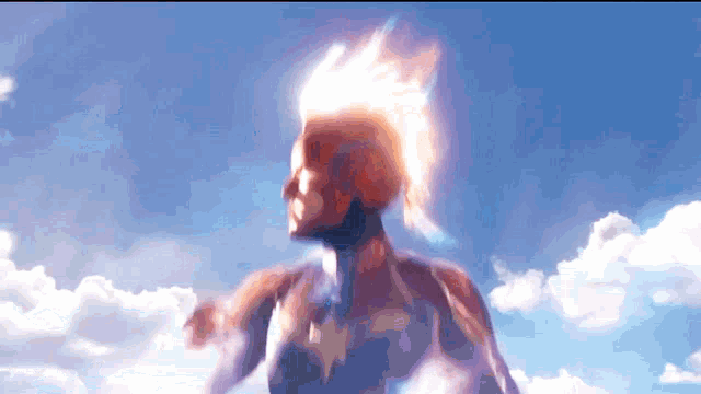 a woman with a star on her chest is flying through a cloudy sky