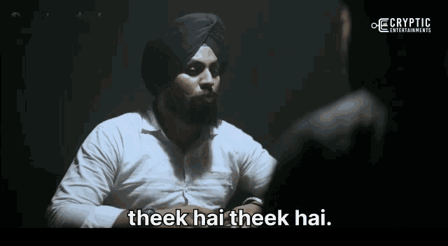 a man in a turban is talking to another man with the words " theek hai theek hai " written below him