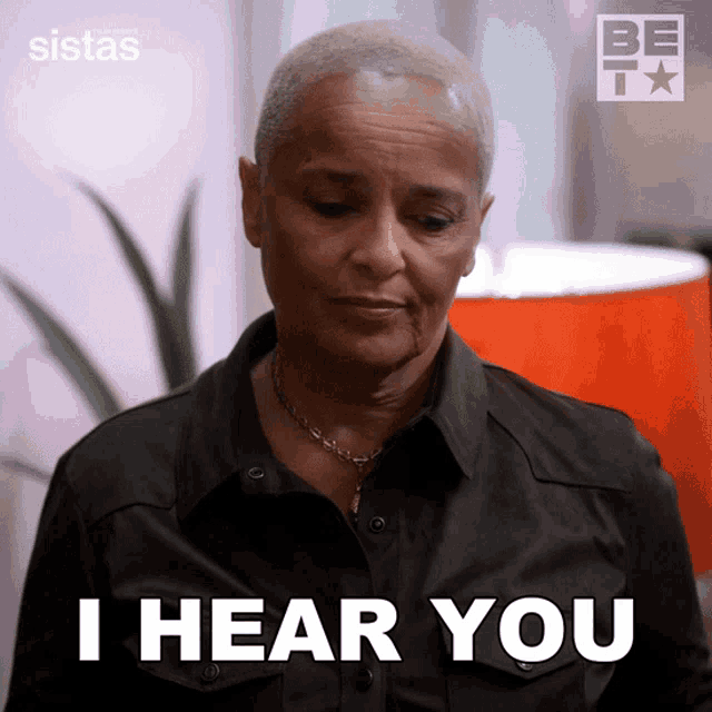 a woman says " i hear you " in front of a be icon