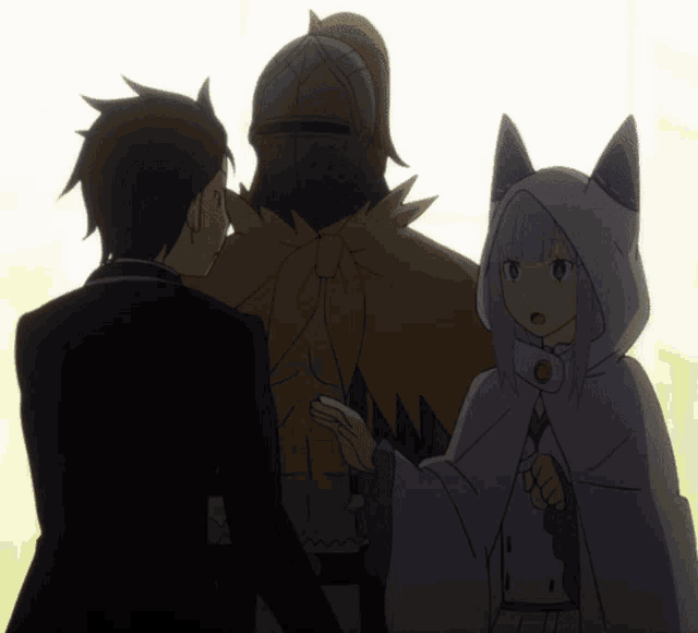 a man in a suit stands next to a woman in a white cape with cat ears
