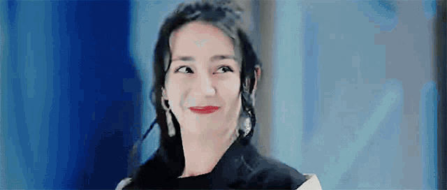 a close up of a woman making a funny face with her eyes closed and red lips .