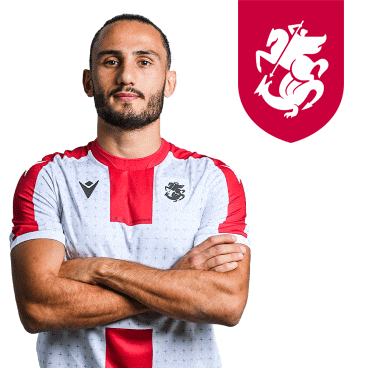 a man with his arms crossed is wearing a red and white shirt