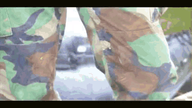 a person wearing a pair of camouflage pants