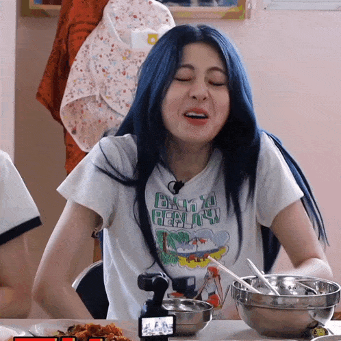 a girl with blue hair is wearing a white shirt that says tokyo hawaii