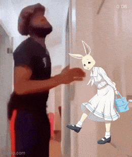 a man is standing next to a cartoon rabbit holding a watering can .