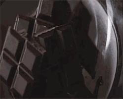 a close up of chocolate being poured into a bowl .
