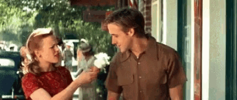 a man and woman are standing next to each other on a sidewalk .