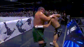 two men are fighting in a wrestling ring with a banner that says ' x-treme ' on it