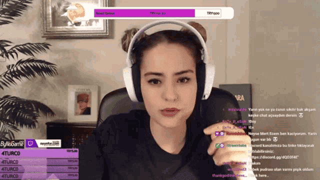 a woman wearing headphones is looking at a screen that says 4turco on it