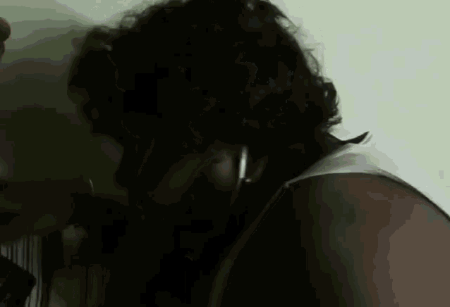 a close up of a person 's face with a white shirt on