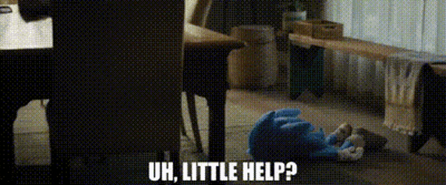 a stuffed animal is laying on the floor with the words `` uh , little help '' written above it .