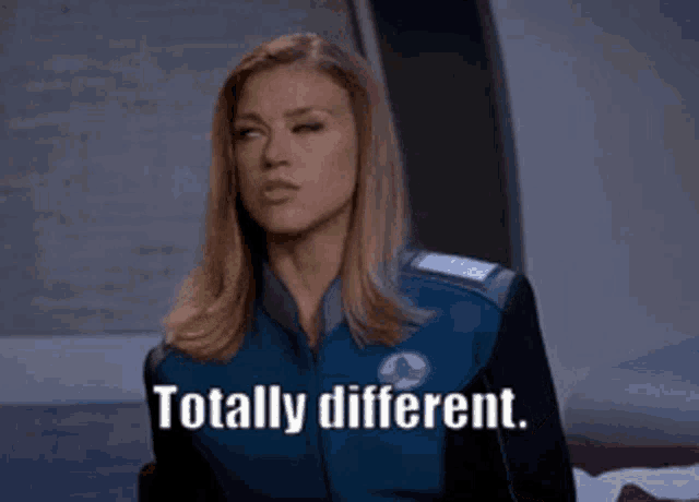 a woman wearing a blue jacket says totally different