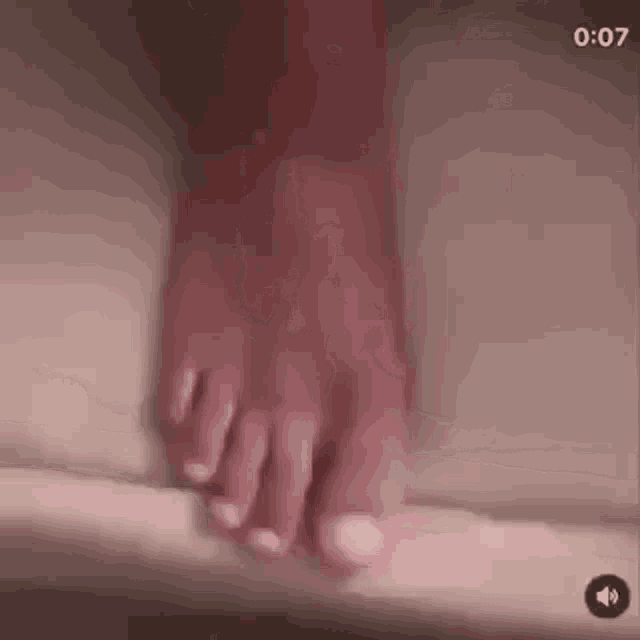 a close up of a person 's foot standing on a bathtub .