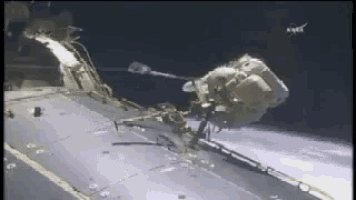 a man in a space suit is being lifted into space