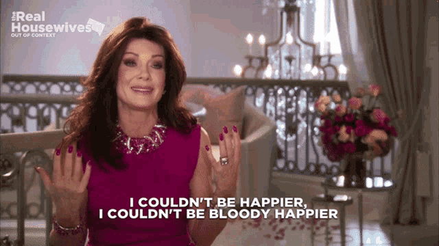 a woman in a pink dress says i couldn 't be happier