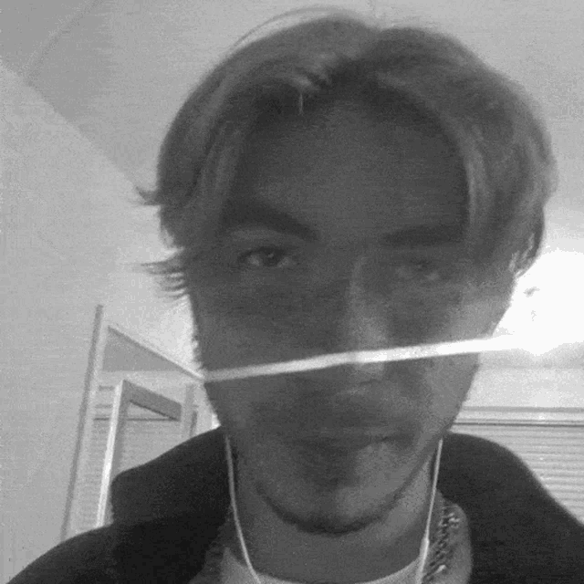 a black and white photo of a man wearing earphones