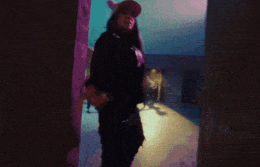 a blurry picture of a woman standing in a dark room with a sign that says ' lg ' on it