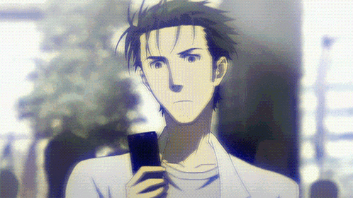 a man in a white shirt holds a cell phone in his right hand