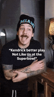 a man wearing a miami hat says " kendrick better play not like us at the super bowl "