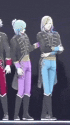 a group of anime characters are standing next to each other on stage .