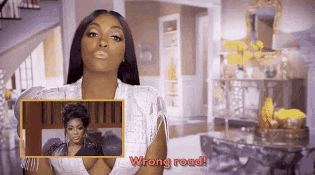 a woman in a white dress is standing in front of a living room and says wrong road