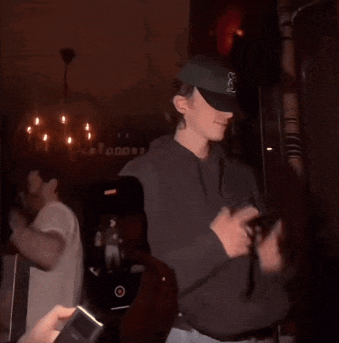 a man wearing a hoodie and a baseball cap with the letter g on it