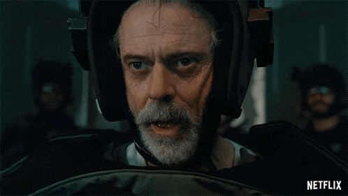 a man with a beard wearing a helmet and headphones with the word alright on the bottom