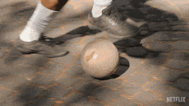 a person kicking a soccer ball with netflix written on the bottom