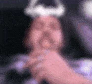 a blurry picture of a person with horns