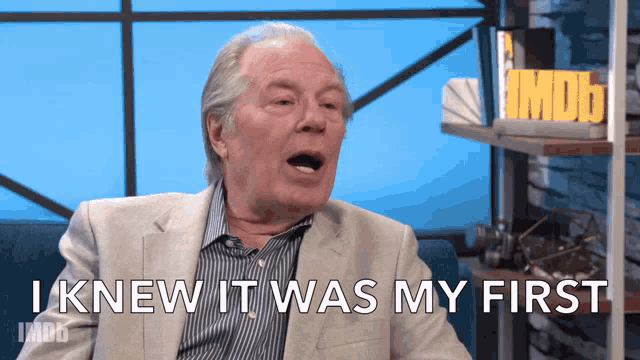 a man is sitting on a couch and says i knew it was my first