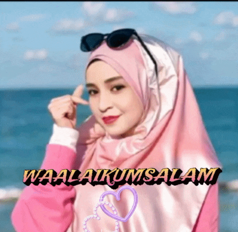 a woman wearing a pink hijab and sunglasses says waalaikum salam