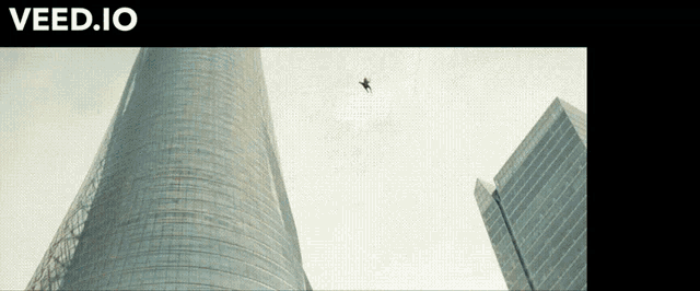 a website called veed.io has a picture of a plane flying over a building