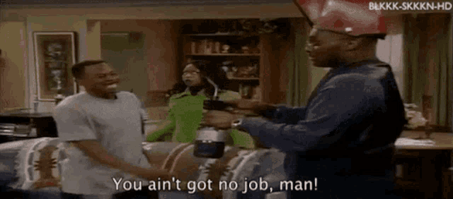 a group of people are standing in a living room and one of them is saying you ain 't got no job man .