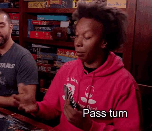 a man wearing a pink hoodie that says pass turn on it