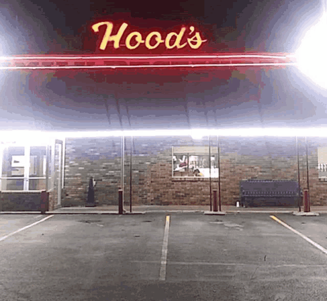 a neon sign for hood 's diner is lit up at night