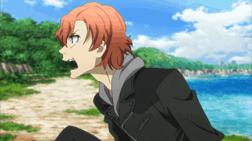 a man with red hair and a black jacket screams in front of the ocean